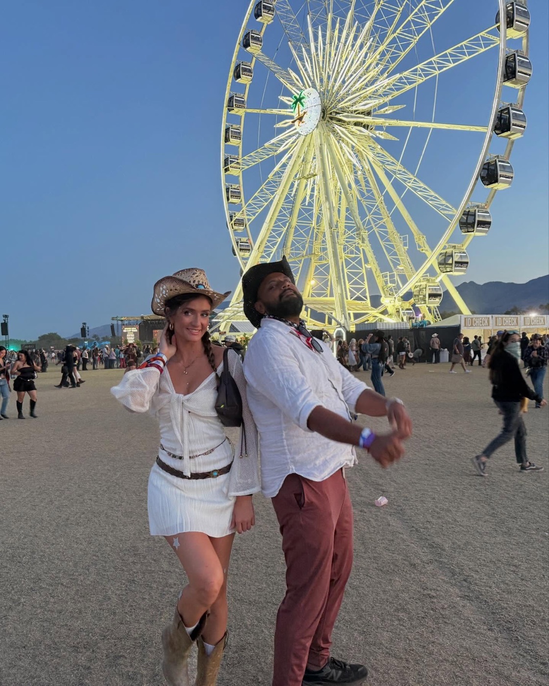 two founding members in cowboy hats under the stagecoach ferris wheel